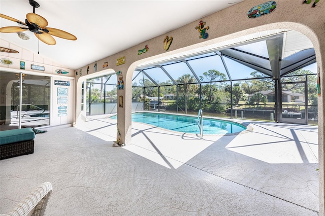 pool with a lanai, a patio area, and ceiling fan