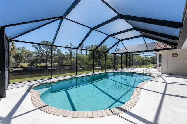 outdoor pool featuring a patio area and glass enclosure