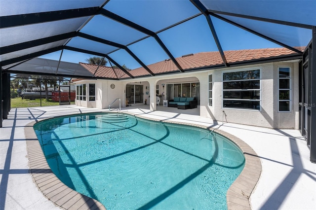 outdoor pool with a patio area, an outdoor living space, and a lanai