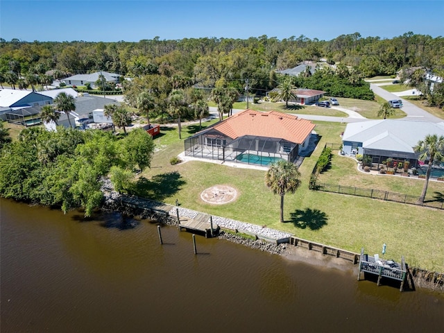 aerial view featuring a forest view and a water view