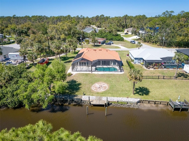 aerial view featuring a forest view and a water view