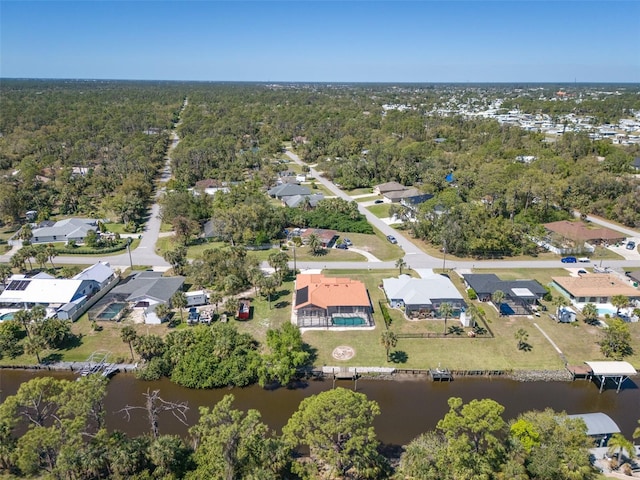 aerial view with a residential view, a view of trees, and a water view