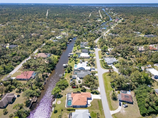 aerial view with a forest view and a water view