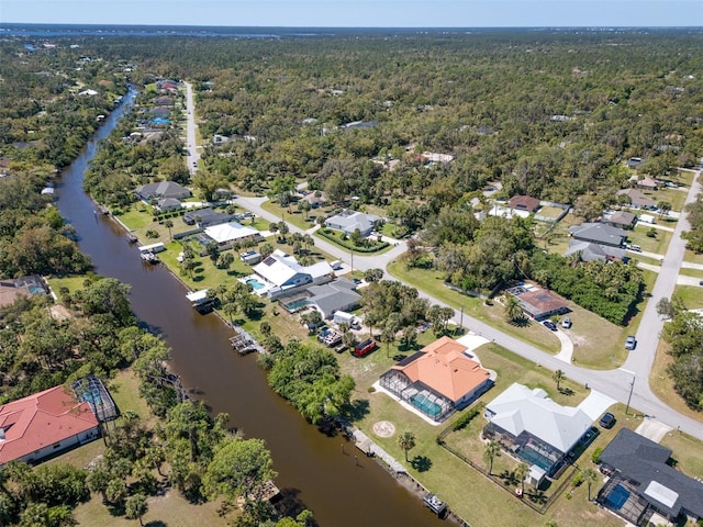 birds eye view of property featuring a forest view, a residential view, and a water view