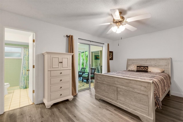 bedroom with wood finished floors, ceiling fan, access to exterior, a textured ceiling, and connected bathroom