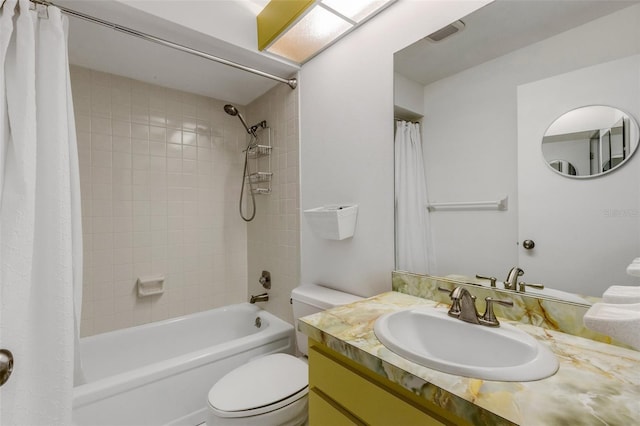 bathroom featuring visible vents, vanity, toilet, and shower / tub combo