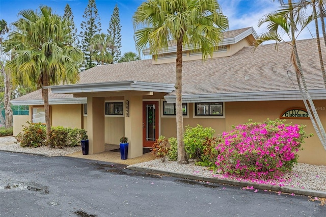 townhome / multi-family property featuring stucco siding and a shingled roof