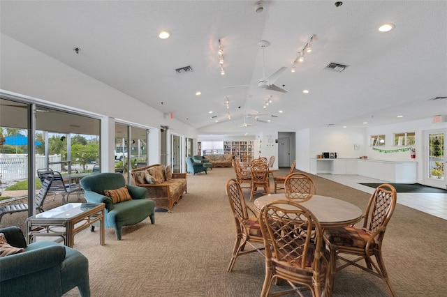 dining room with vaulted ceiling, a healthy amount of sunlight, and visible vents