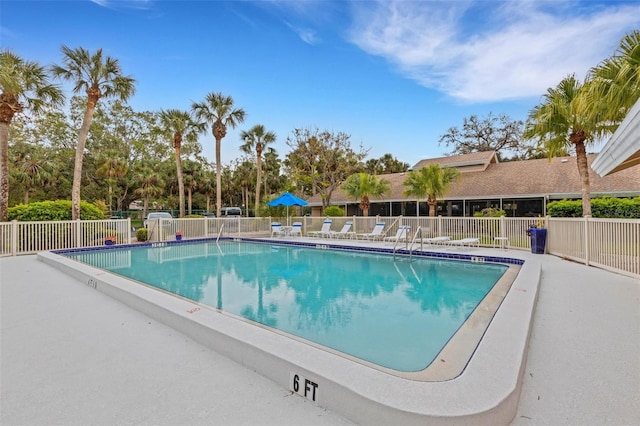 community pool featuring fence