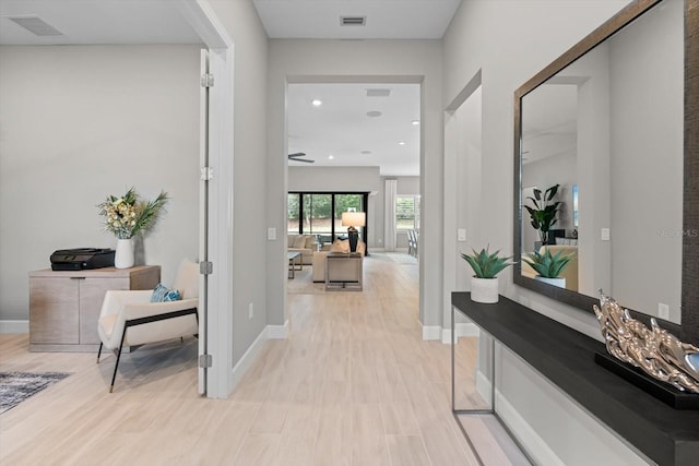 hallway featuring recessed lighting, baseboards, visible vents, and light wood-type flooring