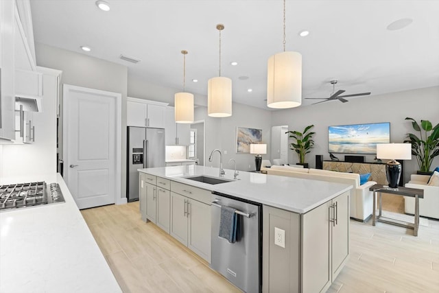 kitchen featuring light countertops, appliances with stainless steel finishes, and a sink