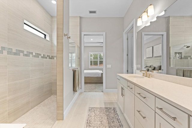 full bath with vanity, visible vents, baseboards, a walk in shower, and ensuite bathroom