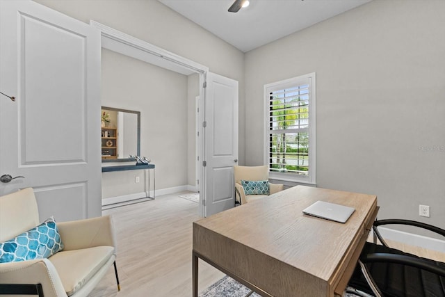 office featuring baseboards and light wood-type flooring