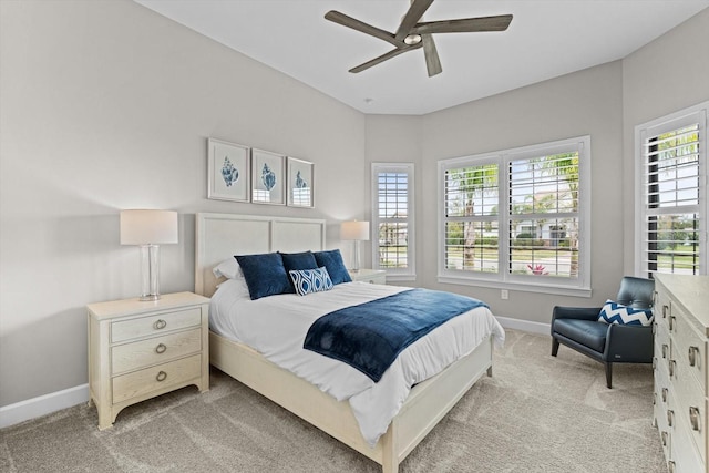 bedroom featuring baseboards, light carpet, and ceiling fan