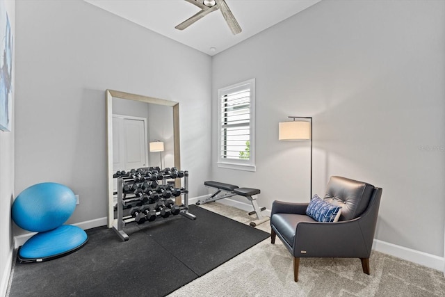 workout area featuring a ceiling fan and baseboards