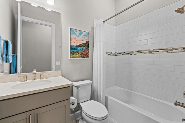 bathroom featuring vanity, shower / tub combo, and toilet