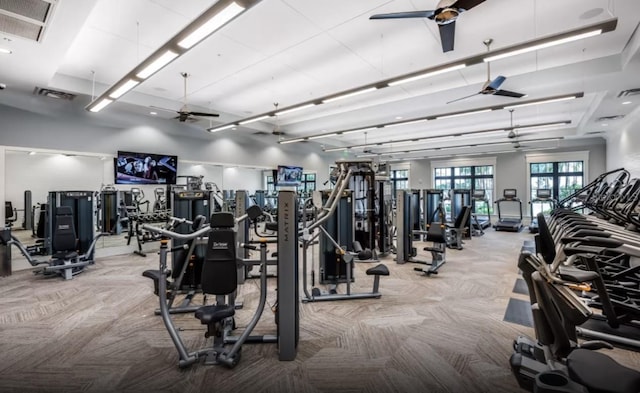 workout area featuring visible vents, ceiling fan, and carpet flooring