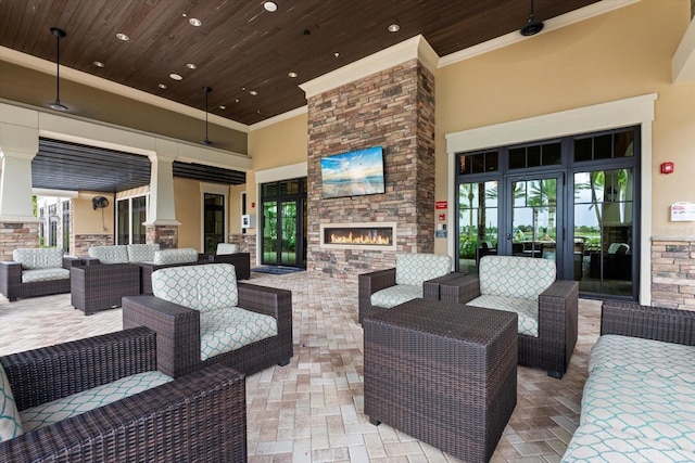 view of patio with an outdoor living space with a fireplace