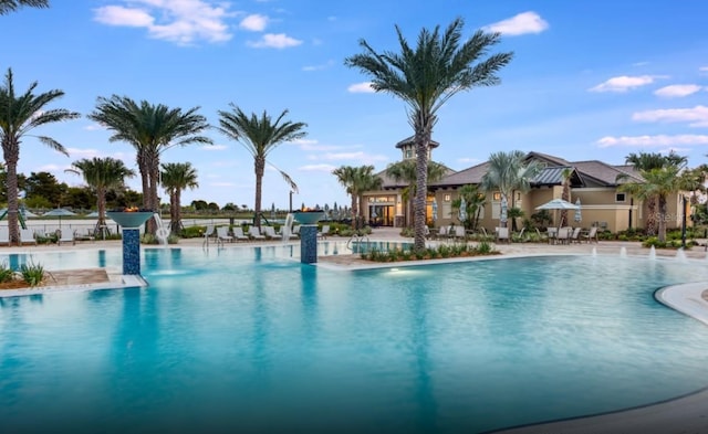 community pool featuring a patio and fence