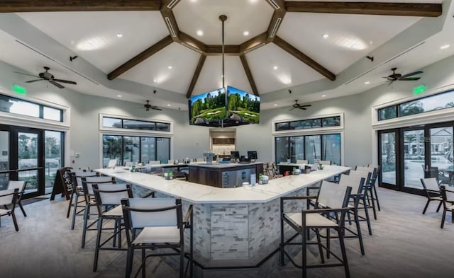 kitchen featuring a wealth of natural light, open floor plan, a large island with sink, and french doors