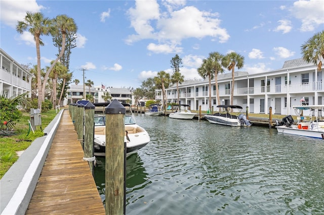 dock area featuring a water view and a residential view