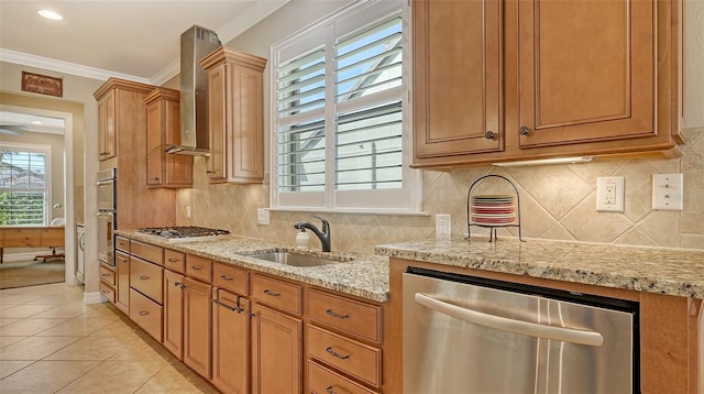 kitchen featuring crown molding, stainless steel appliances, decorative backsplash, a sink, and wall chimney range hood