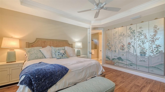 bedroom featuring ornamental molding, visible vents, ceiling fan, and light wood finished floors