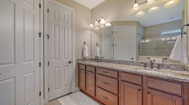 bathroom featuring double vanity, a sink, and a walk in shower