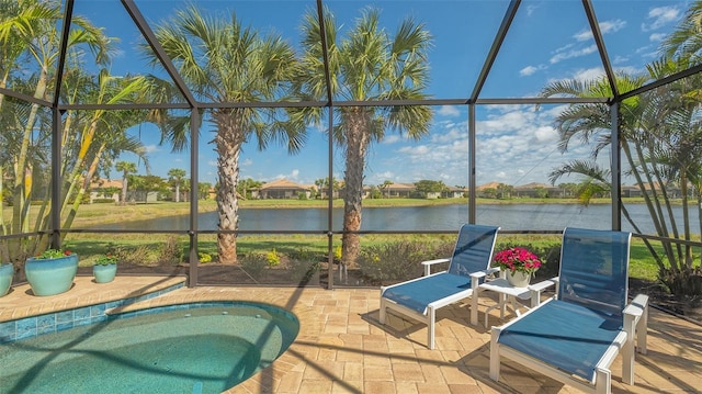 exterior space featuring glass enclosure and a water view