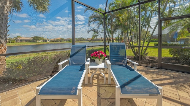 view of swimming pool with a lawn, a water view, and a lanai