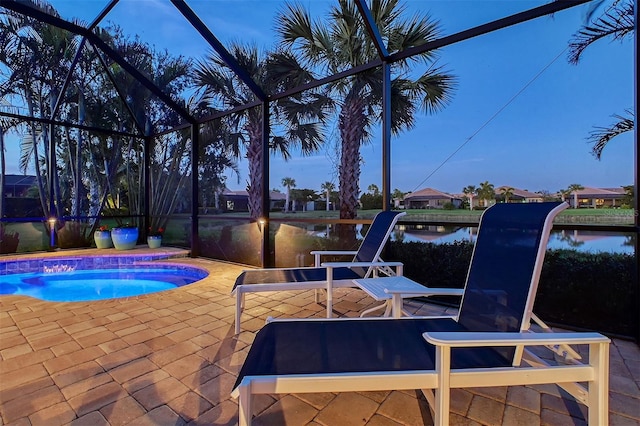 view of pool with a water view, glass enclosure, a swimming pool, and a patio