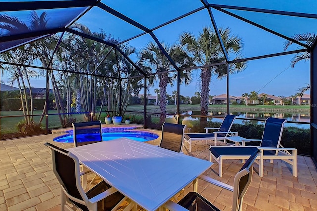 view of patio / terrace with a lanai, a water view, and an outdoor pool