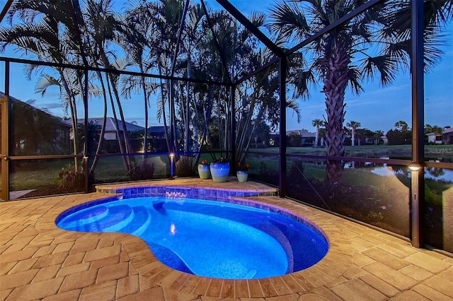 view of pool with a lanai, a pool, and a patio