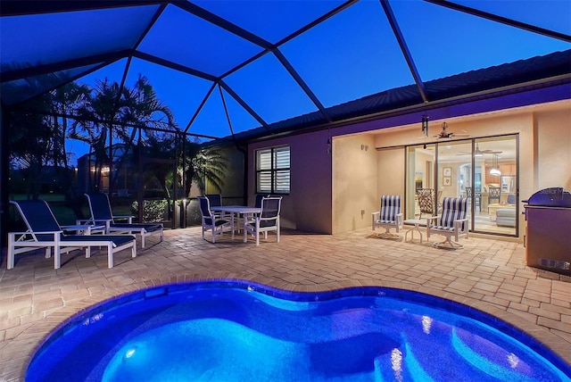 outdoor pool featuring glass enclosure, outdoor dining space, and a patio area