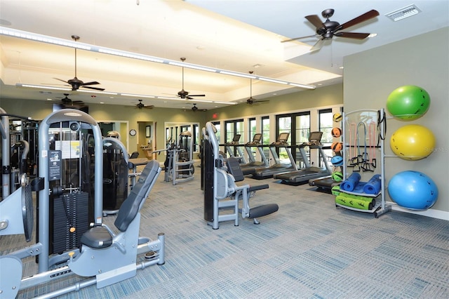 workout area with carpet floors, visible vents, and baseboards