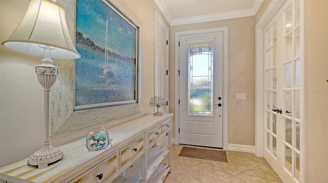 doorway to outside featuring light tile patterned flooring, crown molding, and baseboards