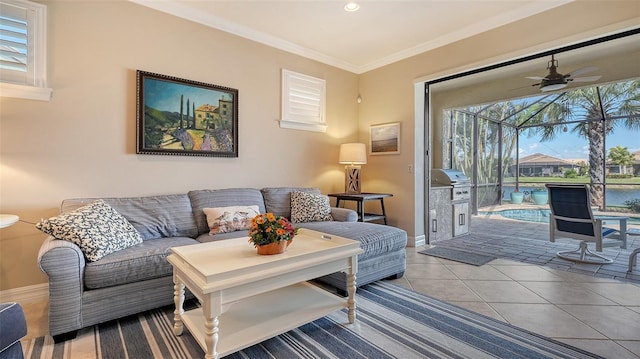 living area with recessed lighting, ornamental molding, ceiling fan, baseboards, and tile patterned floors