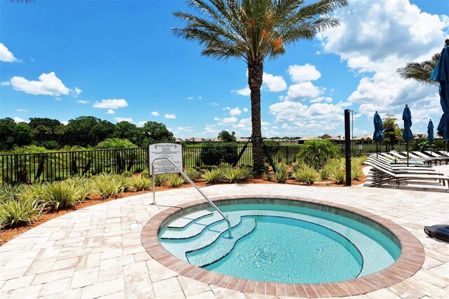 view of swimming pool featuring fence private yard and a patio