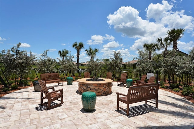 view of patio / terrace featuring an outdoor fire pit and fence