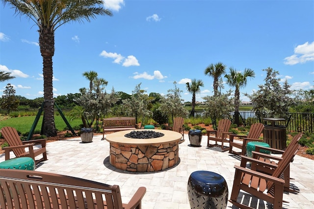 view of patio / terrace with a fire pit and fence