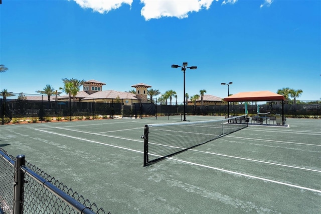 view of sport court with fence and a gazebo