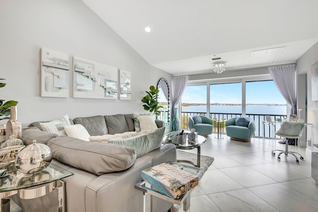 1602 Stickney Point Rd Unit 404, Sarasota, FL 34231 - living room featuring tile patterned flooring, a water view, and high vaulted ceiling