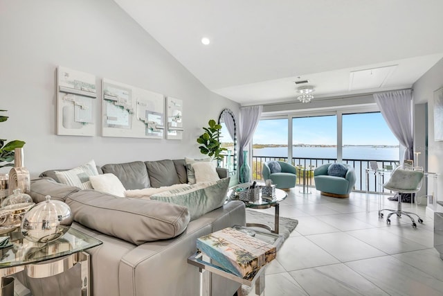 living room featuring high vaulted ceiling, a water view, visible vents, and tile patterned floors