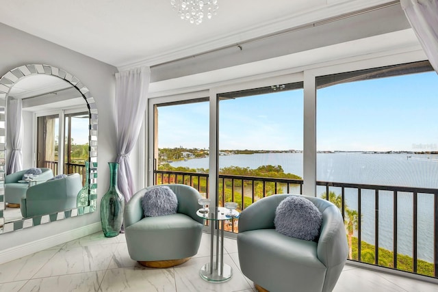 sunroom / solarium featuring a water view