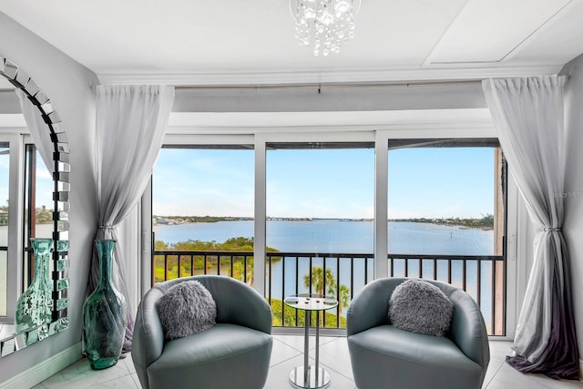 sunroom / solarium with a water view, plenty of natural light, and a notable chandelier