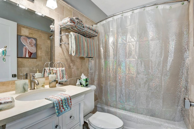 bathroom with tile walls, backsplash, toilet, shower / tub combo, and vanity