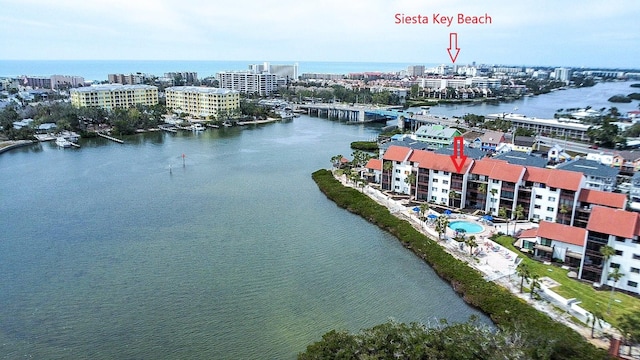 birds eye view of property featuring a water view and a city view