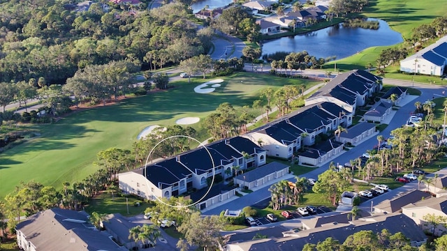 aerial view with view of golf course, a water view, and a residential view