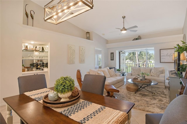 tiled dining room with high vaulted ceiling and ceiling fan