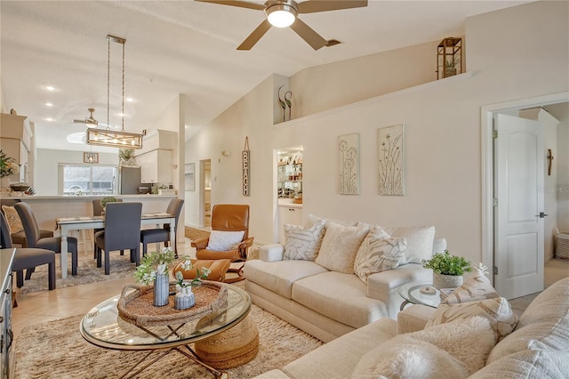 living area with light tile patterned flooring, a ceiling fan, and vaulted ceiling